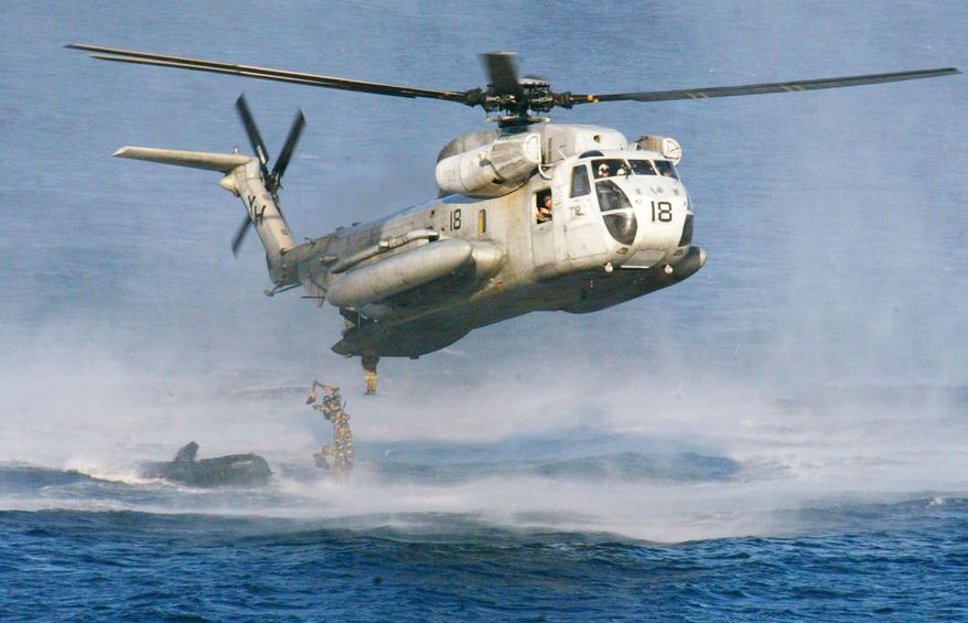 In this Feb. 18, 2003, file photo, U.S. Marines and their Philippine counterparts jump from a US Marines CH-53D Sea Stallion helicopter at Ternate in Cavite province south of Manila. The U.S. Coast Guard says two similar Marine helicopters have collided off the Hawaiian island of Oahu, Friday, Jan. 15, 2016. (AP Photo/Bullit Marquez, File) ** FILE **