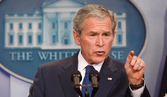 President George W. Bush gestures during a news conference at the White House in Washington on Jan. 12, 2009. (Associated Press) **FILE**