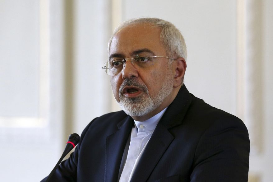 FILE - In this Tuesday, July 28, 2015, file photo, Iranian Foreign Minister Mohammad Javad Zarif speaks with media in a joint press conference with European Union foreign policy chief Federica Mogherini in Tehran, Iran. Iran's foreign minister says an imminent report by the U.N. nuclear agency later Saturday, Jan. 16, 2016, will bring a 'good day' for Iran because it will lead to lifting sanctions. (AP Photo/Vahid Salemi, File )