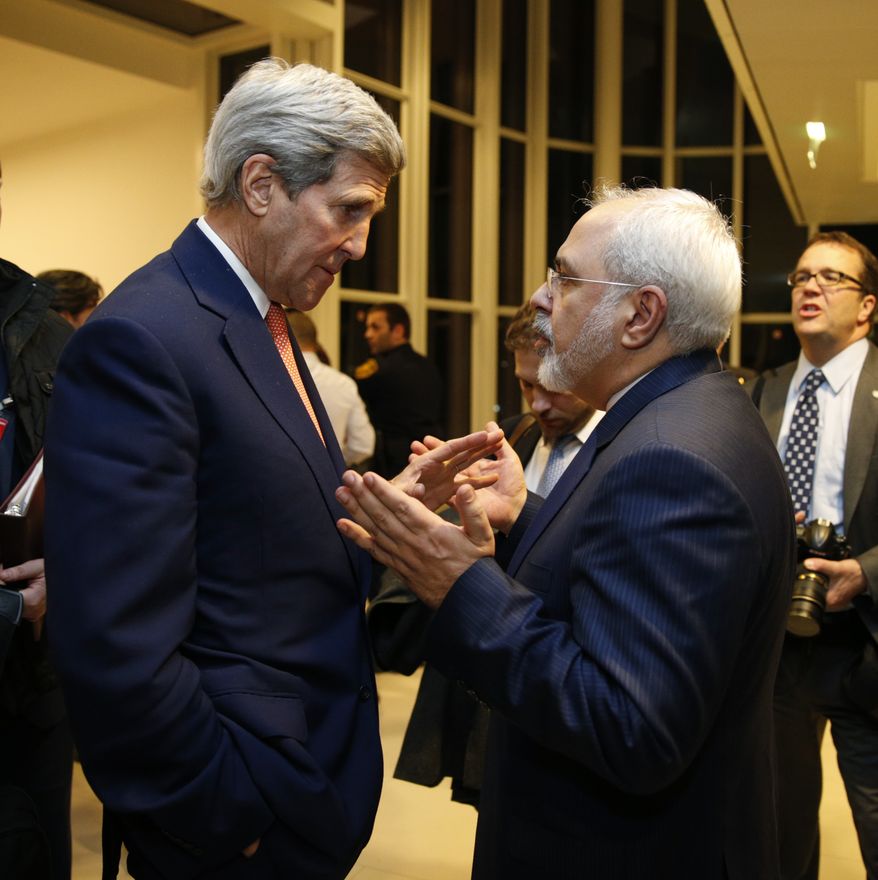 U.S. Secretary of State John Kerry talks with Iranian Foreign Minister Mohammad Javad Zarif, right, after the International Atomic Energy Agency (IAEA) verified that Iran has met all conditions under the nuclear deal, in Vienna, Saturday Jan. 16,  2016. (Kevin Lamarque/Pool via AP) ** FILE **