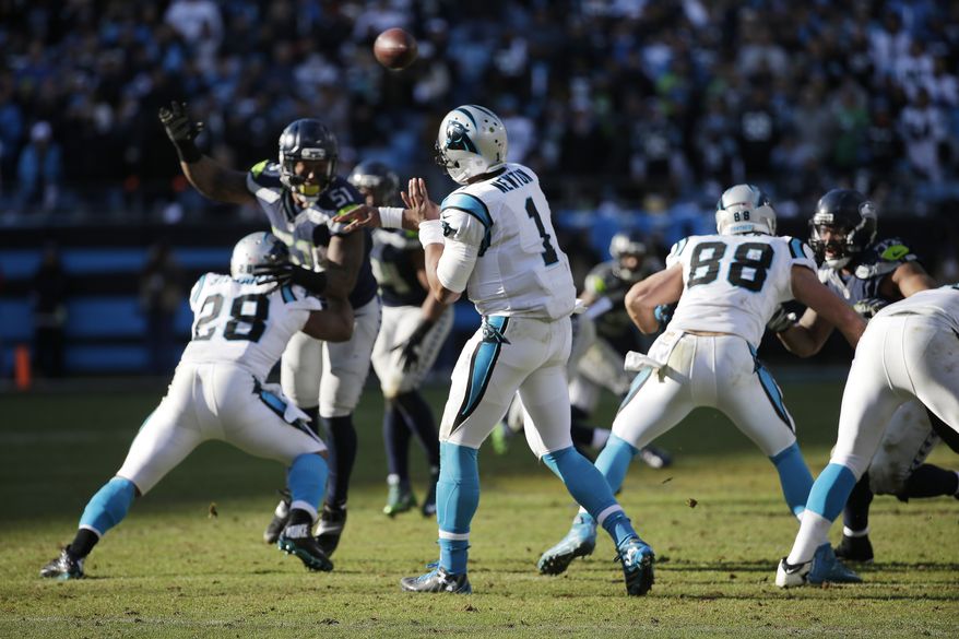 Carolina Panthers quarterback Cam Newton (1) passes against the Seattle Seahawks during the second half of an NFL divisional playoff football game, Sunday, Jan. 17, 2016, in Charlotte, N.C. (AP Photo/Chuck Burton)