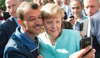 German Chancellor Angela Merkel has pictures taken with refugees in Berlin. (Associated Press/File)
