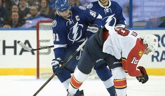 Tampa Bay Lightning center Steven Stamkos (91) takes the puck away from Florida Panthers right wing Reilly Smith (18) during the second period of an NHL hockey game in Tampa, Fla., Sunday, Jan. 17, 2016. (AP Photo/Phelan M. Ebenhack)
