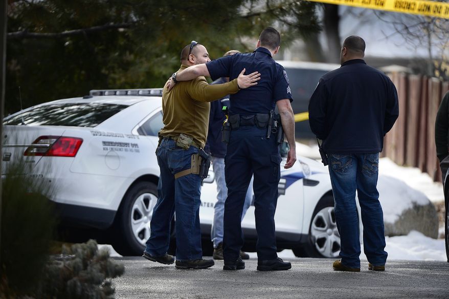 Police talk at the scene of an officer-involved shooting in Holladay, Utah, on Jan. 17, 2016. Utah police Officer Douglas Barney was killed after he was shot by a suspect who was later killed by police. (Scott Sommerdorf/The Salt Lake Tribune via Associated Press)
