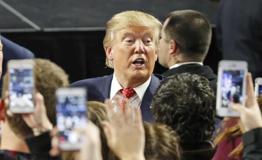 Republican Presidential candidate Donald Trump greets supporters after giving a speech at Liberty University in Lynchburg, Va., Monday, Jan. 18, 2016. (AP Photo/Steve Helber)