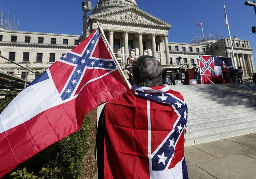 Sons of Confederate Veterans and other groups parade on the grounds of the state Capitol in Jackson, Miss., Tuesday, Jan. 19, 2016, in support of keeping the Confederate battle emblem on the state flag. The public display of Confederate symbols has come under increased scrutiny since June, when nine black worshippers were massacred at a church in South Carolina. (AP Photo/Rogelio V. Solis)