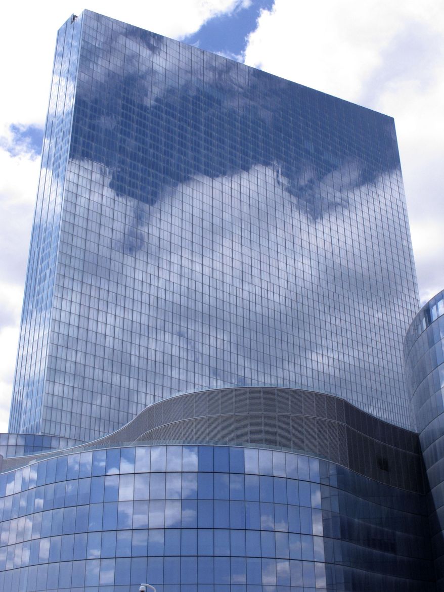 This April 29, 2015 photo shows clouds reflected in the exterior glass of the former Revel casino in Atlantic City, N.J. On Tuesday Jan. 19, 2016, Revel owner Glenn Straub told The Associated Press he plans to reopen the resort with a casino about half the size of what was there under previous owners.(AP Photo/Wayne Parry)