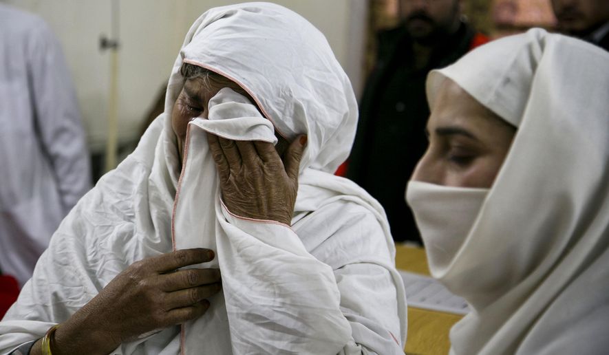 A Pakistani mother cries after her son was injured in an attack in Charsadda town, some 35 kilometers (21 miles) outside the city of Peshawar, Pakistan, Wednesday, Jan. 20, 2016. Gunmen stormed Bacha Khan University named after the founder of an anti-Taliban political party in the country's northwest Wednesday, killing many people, officials said. (AP Photo/B.K. Bangash)
