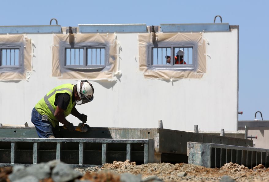 In this file photo taken Friday, April 17, 2015, new cells are under construction at Mule Creek State Prison, in Ione, Calif. California prison officials say federal mandates, which led to more expensive private prison beds, and increased spending on prison construction have caused a $3 billion drop in promised budget savings from what was predicted four years ago.(AP Photo/Rich Pedroncelli, file)