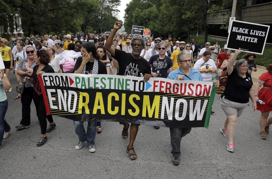 File- This Aug. 8, 2015, file photo shows hundreds taking part in a march in memory of VonDerrit Myers Jr., in St. Louis. Relatives of Myers., who was fatally shot by an off-duty St. Louis police officer have filed a wrongful death lawsuit. The St. Louis Post-Dispatch reports that the suit was filed Wednesday, Jan. 20, 2016, in St. Louis Circuit Court on behalf of the parents of VonDerrit Myers Jr. and the mother of his child. (AP Photo/Jeff Roberson, File)