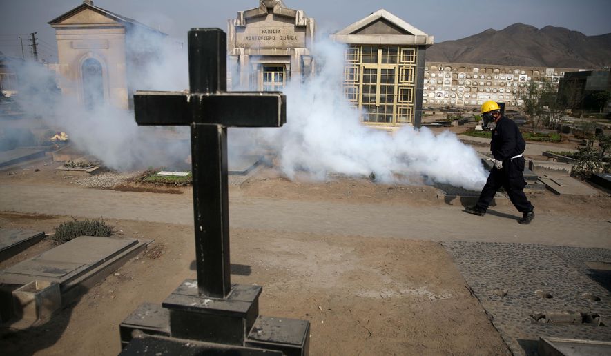 A health worker fumigates to prevent Dengue, Chikunguya and Zika virus, at El Angel cemetery, in Lima, Peru, Wednesday, Jan. 20, 2016. A U.S. warning urging pregnant women to avoid travel to Latin American countries where the mosquito-borne virus is multiplying threatens to depress tourism to the region, one of its few bright spots at a time of deep economic pain. (AP Photo/Martin Mejia)