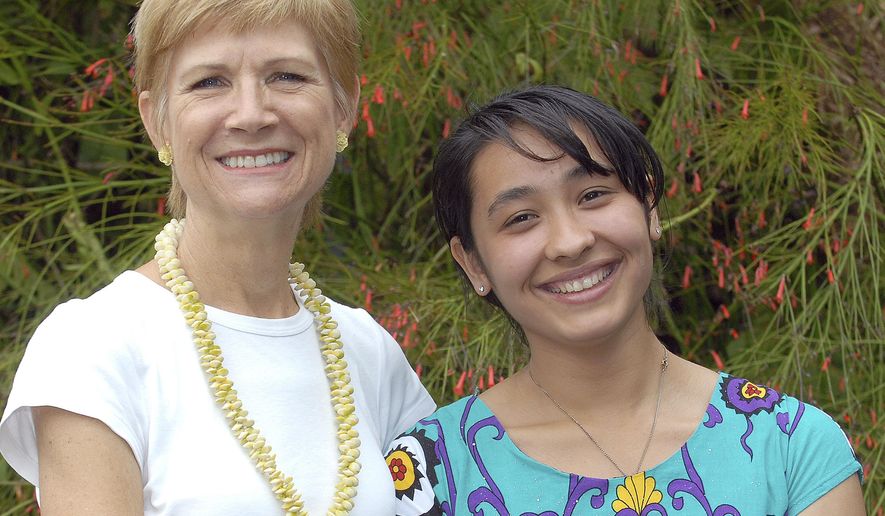 ADVANCE FOR WEEKEND JAN. 23-24, 2016 AND THEREAFTER - In this Jan. 15, 2016 photo host mother Pamela Wang, left, poses with exchange student Mehrangez Rahmatova in Kealakekua, Hawaii. Rahmatova, 19, was on the Big Island in 2012 as a student at Konawaena High School. Living in the United States has been a major shift from the post-Soviet, largely mono-cultural, and patriarchal culture of her homeland, Tajikistan. (Laura Shimabuku/West Hawaii Today via AP)