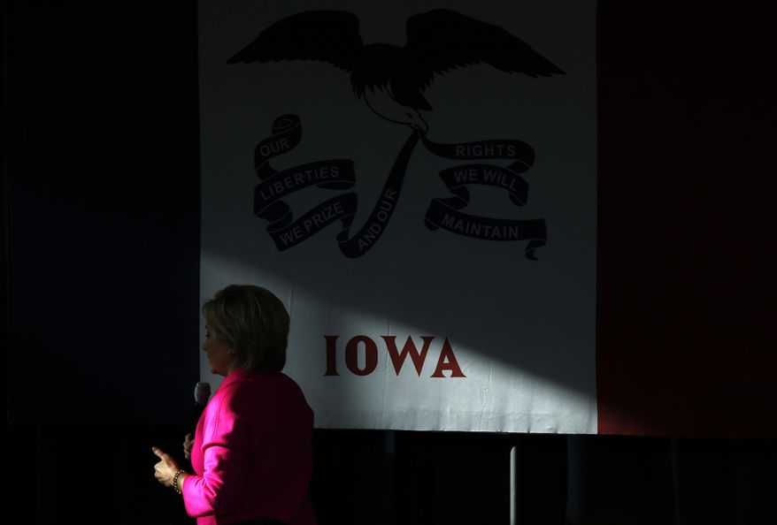 A patch of sunlight shines on the Iowa state flag as Democratic presidential candidate Hillary Clinton speaks during a town hall at Eagle Heights Elementary School in Clinton, Iowa, Saturday, Jan. 23, 2016. (AP Photo/Patrick Semansky)