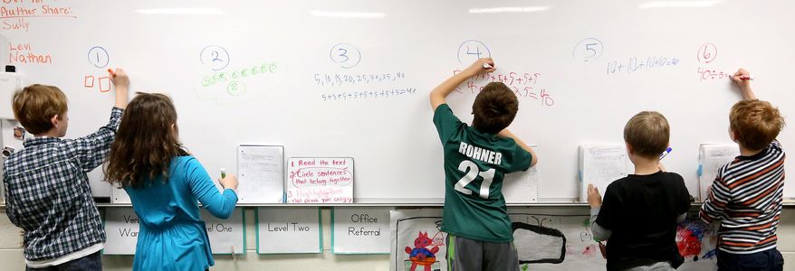 In this Monday, Dec. 14, 2015, file photo, second-graders write out their math solutions at Sageville Elementary School in Sageville, Iowa. Common Core standards for mathematics expect students to conceptually understand math. Multiple strategies, versus a single algorithm, are taught. Forty-two states, including Iowa, Wisconsin and Illinois, have adopted the standards designed to prepare K-12 students for higher education and the professional world. (Jessica Reilly/Telegraph Herald via AP) ** FILE **