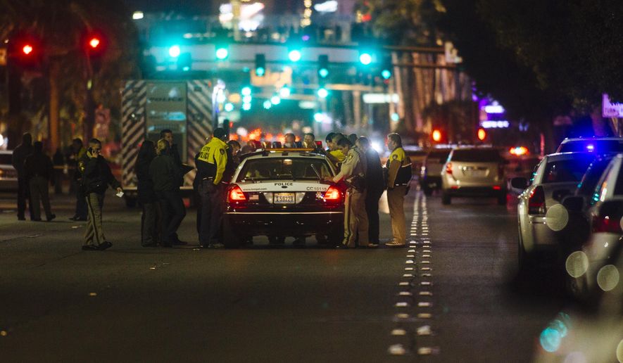 Metro Police officers block Las Vegas Boulevard South at the scene of an officer-involved shooting on Friday, Jan. 22, 2016 in Las Vegas.  According to the Las Vegas Sun, Capt. Matt McCarthy said officers responded to reports of a man walking in and out of Strip traffic waving a gun and pointing it at passers-by. Arriving officers approached the suspect, who did not obey their commands, McCarthy said. Officers fired on the man, who was not hit.  (Mikayla Whitmore /Las Vegas Sun via AP) LAS VEGAS REVIEW-JOURNAL OUT; MANDATORY CREDIT