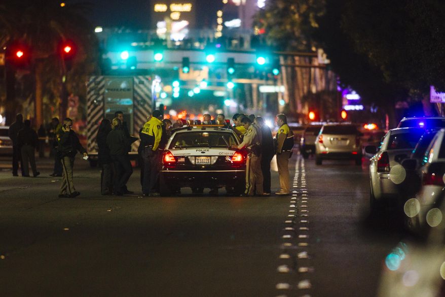 Metro Police officers block Las Vegas Boulevard South at the scene of an officer-involved shooting on Friday, Jan. 22, 2016 in Las Vegas. According to the Las Vegas Sun, Capt. Matt McCarthy said officers responded to reports of a man walking in and out of Strip traffic waving a gun and pointing it at passers-by. Arriving officers approached the suspect, who did not obey their commands, McCarthy said. Officers fired on the man, who was not hit. (Mikayla Whitmore /Las Vegas Sun via AP) LAS VEGAS REVIEW-JOURNAL OUT; MANDATORY CREDIT