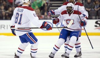 Montreal Canadiens center Lars Eller (81) is congratulated by teammates P.K. Subban and Devante Smith-Pelley, rear, after scoring in overtime against the Toronto Maple Leafs during an NHL hockey game in Toronto on Saturday, Jan. 23, 2016. (Frank Gunn/The Canadian Press via AP)