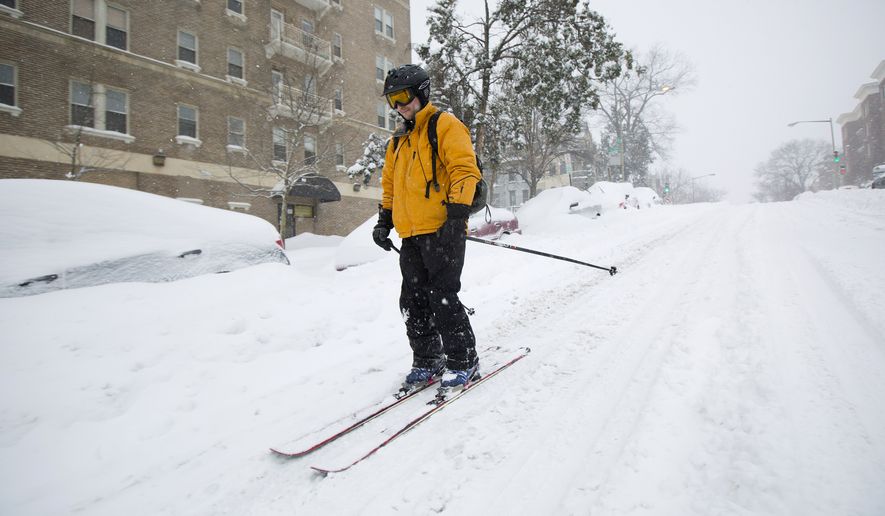 Bryan Gold skis down 13th Street in the Columbia Heights neighborhood of Washington, Saturday, Jan. 23, 2016, as he heads to a friends home to check up on them. Millions of people awoke Saturday to heavy snow outside their doorsteps, strong winds that threatened to increase through the weekend, and largely empty roads as residents from the South to the Northeast heeded warnings to hunker down inside while a mammoth storm barreled across a large swath of the country. (AP Photo/Pablo Martinez Monsivais)
