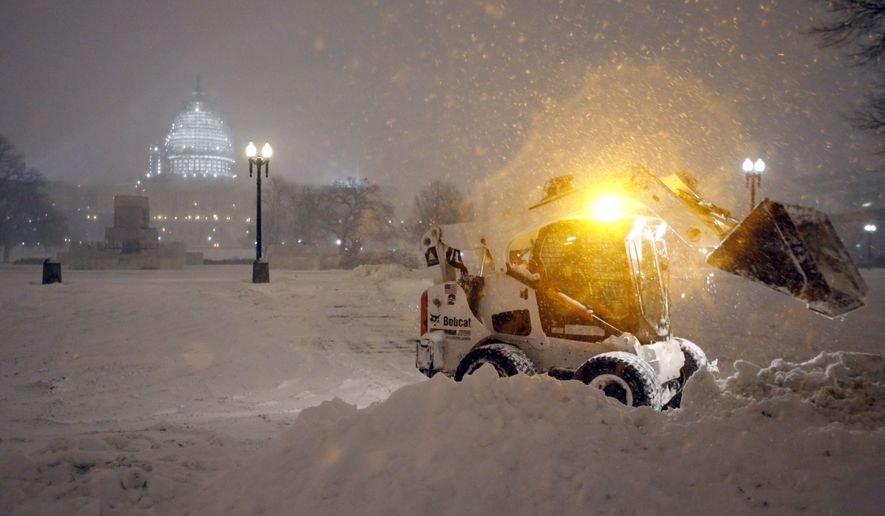 A bobcat piles up snow in front of the U.S. Capitol, as the snow continues to fall, Friday, Jan. 22, 2016, in Washington. (AP Photo/Alex Brandon) ** FILE **