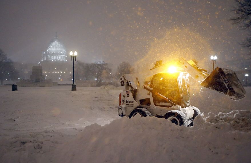 A bobcat piles up snow in front of the U.S. Capitol, as the snow continues to fall, Friday, Jan. 22, 2016, in Washington. (AP Photo/Alex Brandon) ** FILE **