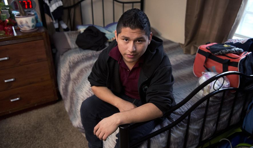 Marvin Velasco, 15, poses at his new home in Los Angeles on Monday, Jan. 11, 2016. In September 2014, Velasco said he soon realized that nine other people lived in the apartment of his first sponsor in the United States, a distant relative whom he had never met. The sponsor told Velasco he would be punished if he left the apartment, and demanded rent payments. When Velasco told the sponsor he wanted to study, the man called the boy's parents in Guatemala, threatening to kick him out if they didn't pay. Then he started withholding food, Velasco said. (AP Photo/Mark J. Terrill)