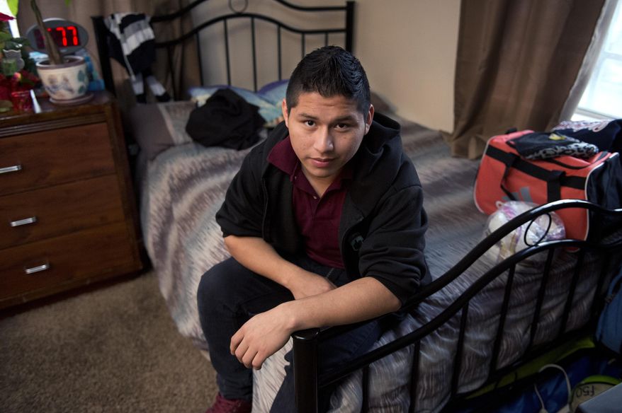 Marvin Velasco, 15, poses at his new home in Los Angeles on Monday, Jan. 11, 2016. In September 2014, Velasco said he soon realized that nine other people lived in the apartment of his first sponsor in the United States, a distant relative whom he had never met. The sponsor told Velasco he would be punished if he left the apartment, and demanded rent payments. When Velasco told the sponsor he wanted to study, the man called the boy's parents in Guatemala, threatening to kick him out if they didn't pay. Then he started withholding food, Velasco said. (AP Photo/Mark J. Terrill)