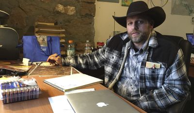 Ammon Bundy sits at a desk he has been using at the Malheur National Wildlife Refuge in Oregon on Friday, Jan. 22, 2016. Bundy is the leader of an armed group occupying a national wildlife refuge to protest federal land policies. (Associated Press)