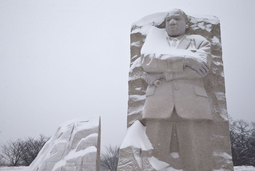 The Martin Luther King, Jr. Memorial is seen with a coating of snow, Saturday, Jan. 23, 2016 in Washington. (AP Photo/Alex Brandon)