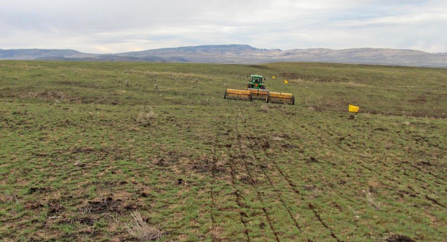 In this 2015 photo provided by the Bureau of Land Management, a rangeland drill reseeds an area burned by the Soda Fire in southwest Idaho. A year after Interior Secretary Sally Jewell shifted the national approach to fighting wildfires across a wide swath of sagebrush country in the West, in an order issued in January 2015, her strategy is turning out to be one of the most significant federal land policy changes in some 80 years, public land experts, outdoor enthusiasts and scientists say. (Bureau of Land Management via AP)