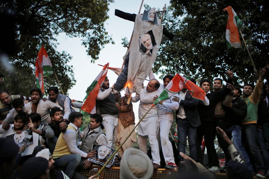 Members of the Indian Youth Congress burn an effigy of Indian Prime Minister Narendra Modi to protest against his visit to Pakistan in New Delhi, India, Friday, Dec. 25, 2015. Modi arrived in Pakistan on Friday, his first visit as prime minister to the Islamic nation that has been India&#x27;s long-standing arch rival in the region. (AP Photo/Altaf Qadri)