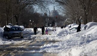 Streets were plowed but sidewalks were covered, forcing pedestrians into streets, after a mammoth blizzard hit the District of Columbia last month. (Associated Press)