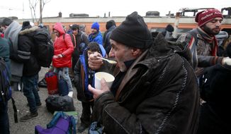 Refugees have a hot soup on the arrival at the transit center for refugees near northern Macedonian village of Tabanovce, before continuing their journey to Serbia, Sunday, Jan. 24, 2016. Macedonia, Serbia and Croatia, the countries on the so-called Balkan migrant corridor that starts in Greece, are only letting in people whose stated final destination is Germany or Austria. (AP Photo/Boris Grdanoski)
