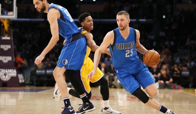 Dallas Mavericks&#x27; Chandler Parsons, right, drives past Los Angeles Lakers&#x27; Anthony Brown, center, while Mavericks&#x27; Salah Mejri, left, sets a pick during the first half of an NBA basketball game, Tuesday, Jan. 26, 2016, in Los Angeles. (AP Photo/Danny Moloshok)