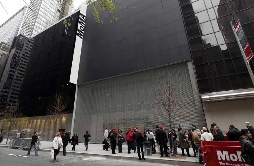 FILE - In this Nov. 20, 2004, file photo, people pass in front of the Museum of Modern Art in New York. The museum’s revised expansion plan was made public, Wednesday, Jan. 27, 2016. The work will add about 50,000 square feet of exhibition space, enhance galleries and replace a 1939 staircase that was removed. The museum will remain open throughout the construction as the three-phase, $400 million project, is expected to be completed in 2019 or 2020. (AP Photo/Gregory Bull, File)