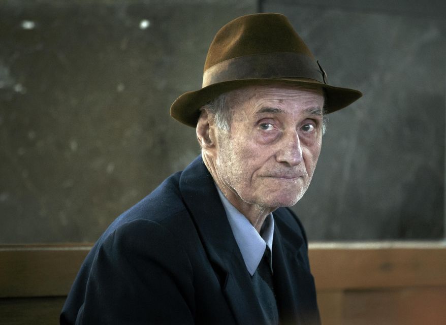 FILE - This is a Wednesday, Nov. 25, 2015 file photo of former communist prison commander Alexandru Visinescu, 90, as he waits for his hearing to start at an appeals court in Bucharest, Romania. Prosecutors at Romania's top appeals court on Wednesday Jan. 27, 2016 called for a 20-year sentence for Alexandru Visinescu, a communist-era prison commander convicted of crimes against humanity for the deaths of 12 political prisoners. (AP Photo/Vadim Ghirda, File)