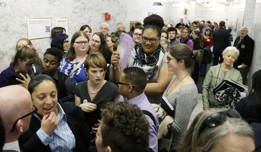 People pack a hallway outside a Washington Senate hearing room, Wednesday, Jan. 27, 2016, at the Capitol in Olympia, Wash., as they wait to listen to public testimony regarding a bill that would eliminate Washington’s new rule allowing transgender people use gender-segregated bathrooms and locker rooms in public buildings consistent with their gender identity. (AP Photo/Ted S. Warren)