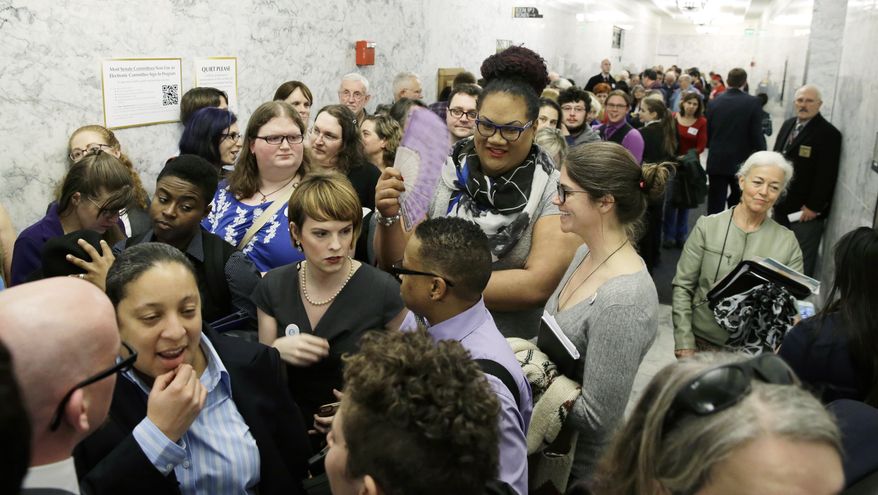 People pack a hallway outside a Washington Senate hearing room, Wednesday, Jan. 27, 2016, at the Capitol in Olympia, Wash., as they wait to listen to public testimony regarding a bill that would eliminate Washington’s new rule allowing transgender people use gender-segregated bathrooms and locker rooms in public buildings consistent with their gender identity. (AP Photo/Ted S. Warren)