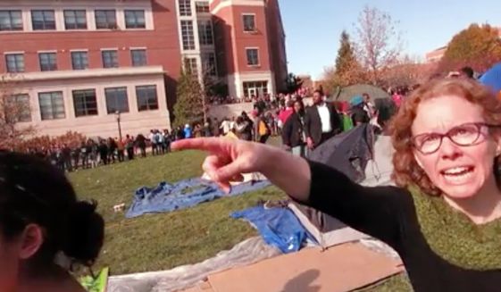 Melissa Click, an assistant professor in the University of Missouri&#39;s communications, gestures during a run-in with student journalists on Nov. 9, 2015, at a campus protest that followed the resignations of the university system&#39;s president and the Columbia campus&#39; chancellor in Columbia, Missouri. (Associated Press)