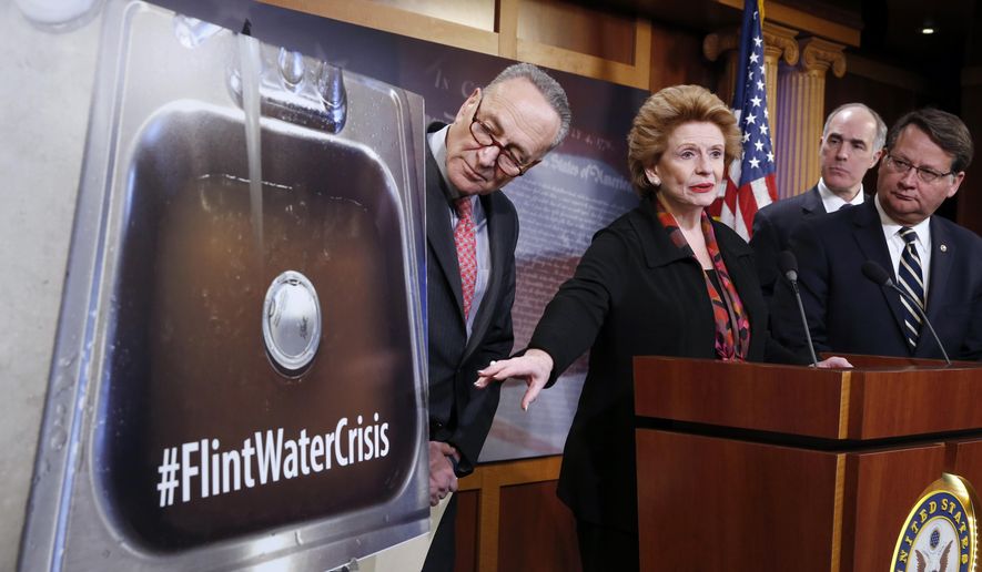 Sen. Debbie Stabenow, D-Mich., second from left, accompanied by, from left, Sen. Charles Schumer, D-N.Y., Sen. Bob Casey, D-Pa., and Sen. Gary Peters, D-Mich., discusses proposed legislation to help Flint, Mich. with their current water crisis, Thursday, Jan. 28, 2016, during a news conference on Capitol Hill in Washington. (AP Photo/Alex Brandon)