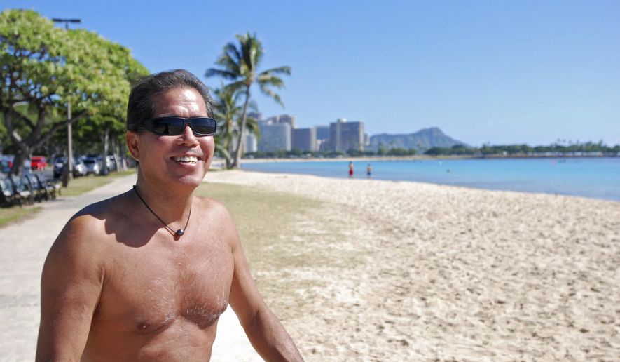 In this photo taken Tuesday Jan. 26, 2016, Danny Quan smiles while sitting at Ala Moana Beach Park in Honolulu. A new study looking at the five elements of a well ordered life, such as financial security, sense of community and purpose, ranks Hawaii just ahead of Alaska. (AP Photo/Audrey McAvoy)