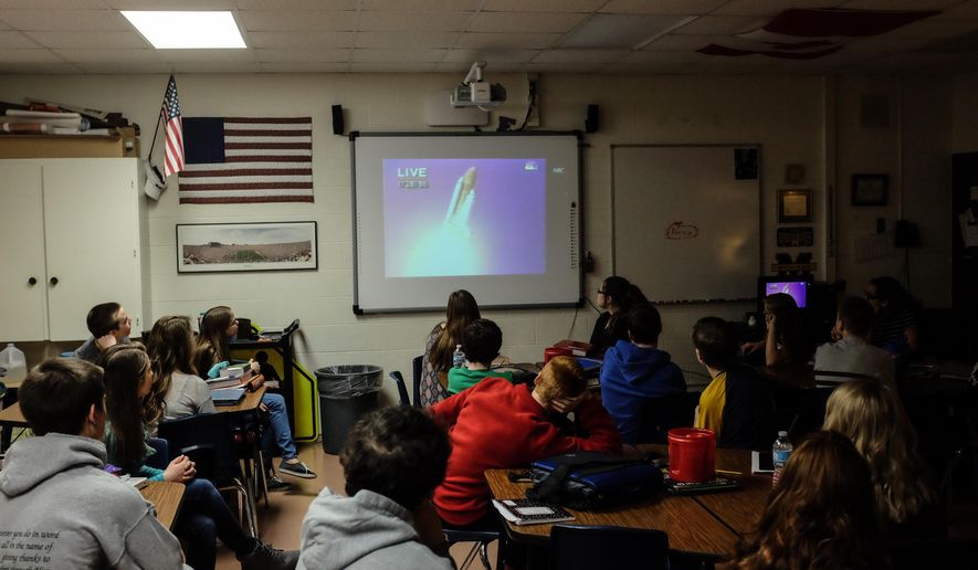 Eighth grade students watch a video of Challenger space shuttle launch Thursday, Jan. 28, 2016, at Christa McAuliffe Middle School in Bangor Township, Mich. The students were learning about the teacher-astronaut, whom the school is named after. Thursday marks the space shuttle accident's 30th anniversary. Andrew Dodson/The Bay City Times via AP) LOCAL TELEVISION OUT; LOCAL INTERNET OUT; MANDATORY CREDIT