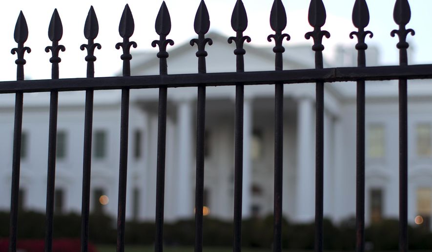 In this Sept. 23, 2014, photo, the White House is seen through the North Lawn perimeter fence in Washington. (AP Photo/Carolyn Kaster) **FILE**