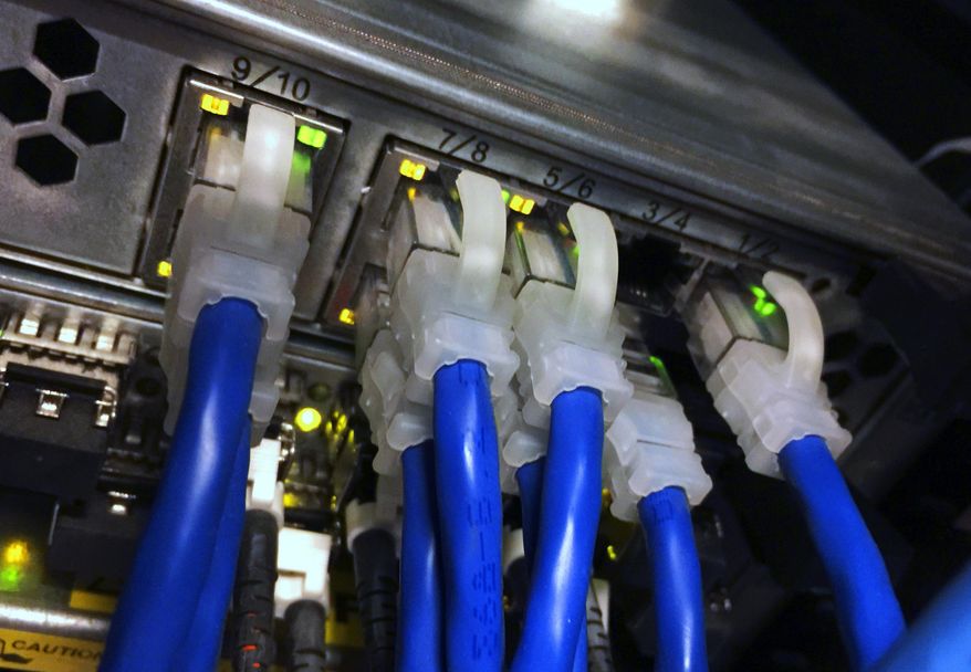 FILE - In this March 5, 2015, file photo, cables are connected to a server capable of handling an email server at the Washington bureau of The Associated Press. News that Hillary Clinton’s home email server contained top-secret messages brings renewed attention to the security of her mail system and to the laws and regulations that control classified information. The new disclosure, and the question of whether it exposes her to more serious legal problems, was certain to escalate political heat on the Democratic presidential candidate just days before the first ballots are cast in Iowa in the 2016 nominating process. (AP Photo/Jon Elswick, File)