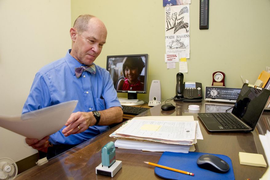 ADVANCE FOR WEEKEND JAN. 30-31, 2016 AND THEREAFTER- In this Jan. 20, 2016 photo, Dr. Christopher Marsh fills out paperwork to appeal imaging tests that were denied in Honolulu. The Hawaii Medical Service Association is imposing a new pre-authorization requirement that doctors say is delaying critical imaging tests and resulting in harmful consequences for patients. (Craig T. Kojima/Honolulu Star-Advertiser via AP)