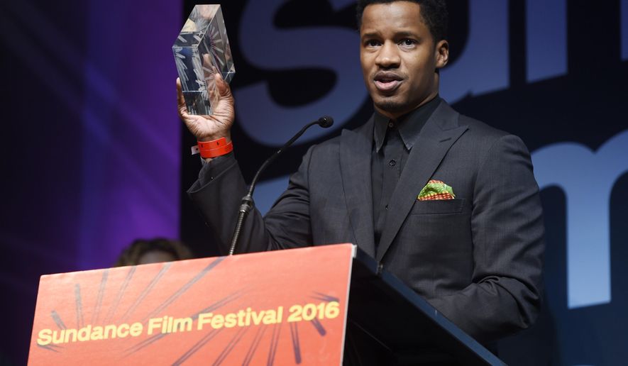 Nate Parker, the star, director and producer of "The Birth of a Nation," holds aloft the U.S. Dramatic Audience Award for the film during the 2016 Sundance Film Festival Awards Ceremony on Saturday, Jan. 30, 2016, in Park City, Utah. The film also won the U.S. Grand Jury Prize: Dramatic award. (Photo by Chris Pizzello/Invision/AP)
