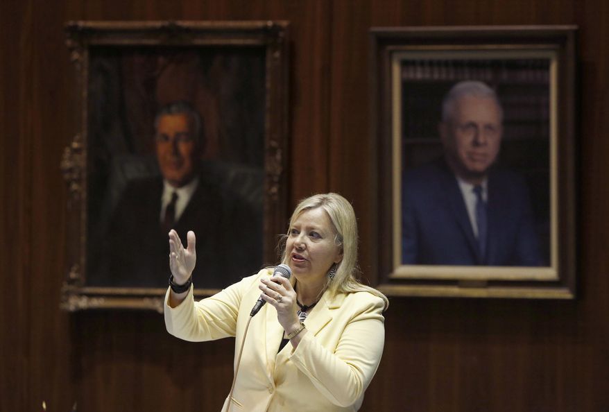 FILE - In this April 17, 2014, file photo, Rep. Debbie Lesko, R-Peoria, answers questions about an amendment to a bill at the Arizona Capitol in Phoenix. A major overhaul of the state’s badly underfunded pension plan for public safety workers is expected to be introduced in the Arizona Senate on Monday, Feb. 1, 2016. Lesko will introduce the bill. (AP Photo/Ross D. Franklin, File)