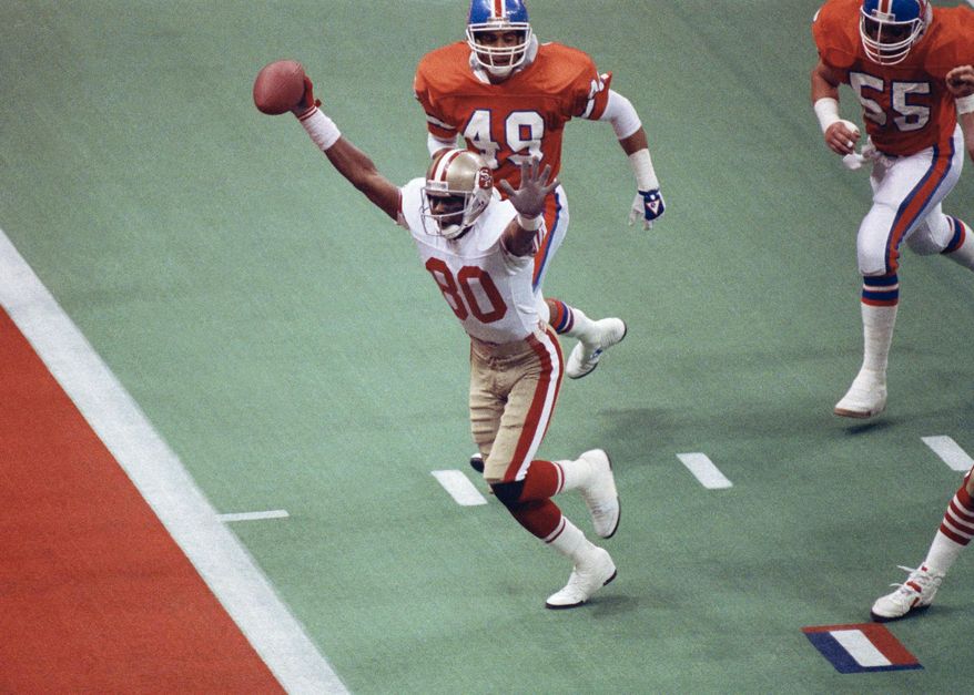 FILE - In this Jan. 28, 1990, file photo, San Francisco 49ers wide receiver Jerry Rice celebrates his first-quarter touchdown against the Denver Broncos during NFL football's Super Bowl XXIV in New Orleans. Joe Montana and the 49ers managed to outscore their own nickname in this 55-10 trampling of the Broncos, still the most points ever scored by a Super Bowl team and the largest margin of victory in the game’s history. (AP Photo/Bill Haber/FIle)