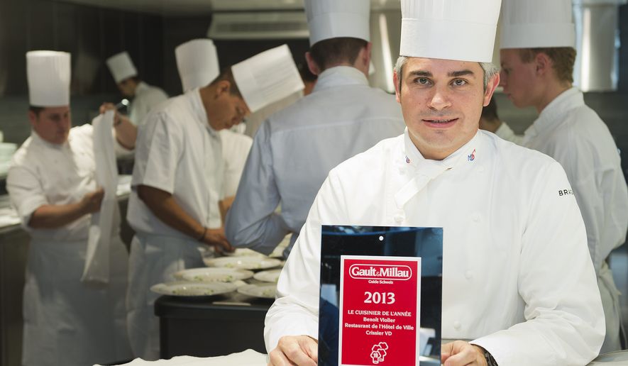 Chef Benoit Violier poses with the certificate as Chef of the year in his kitchen in the Hotel de Ville in Crissier, Switzerland, in this Oct. 8, 2012, file photo. Swiss police said Monday, Feb. 1, 2016, 3-star chef Violier, whose restaurant near Lausanne recently topped a list of the world's best, has been found dead of an apparent self-inflicted gunshot. (Jean-Christophe Bott/Keystone via AP)