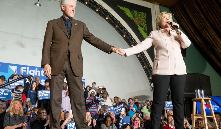 Democratic presidential candidate Hillary Clinton holds hands with her husband former President Bill Clinton as she takes the stage to speak at a rally at the Col Ballroom in Davenport, Iowa, Friday, Jan. 29, 2016. (AP Photo/Andrew Harnik)