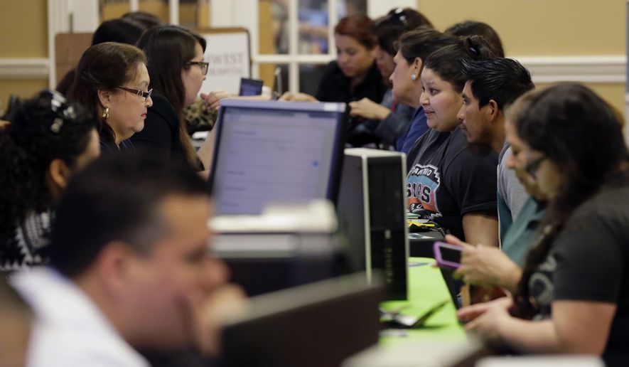 Affordable Care Act navigators help guide those looking for insurance during an enrollment event in San Antonio. (Associated Press)